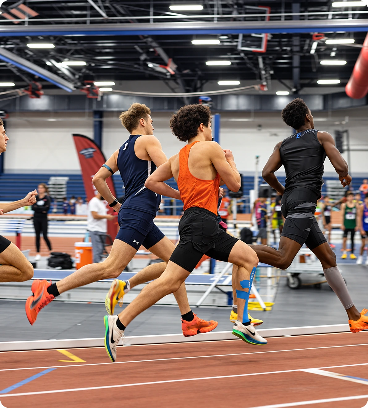 Group of athletes racing on an indoor track, representing nervous system recovery and readiness for athletes