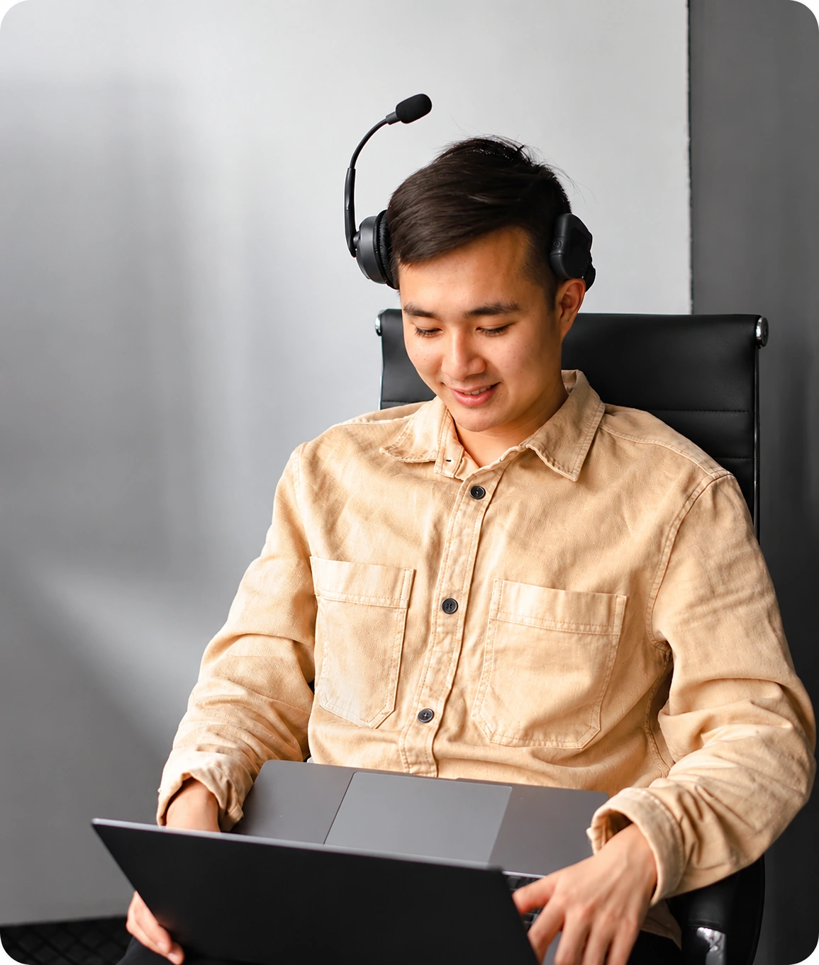 Professional wearing a headset and using a laptop, representing burnout, nervous system dysregulation, and reduced cognitive performance.